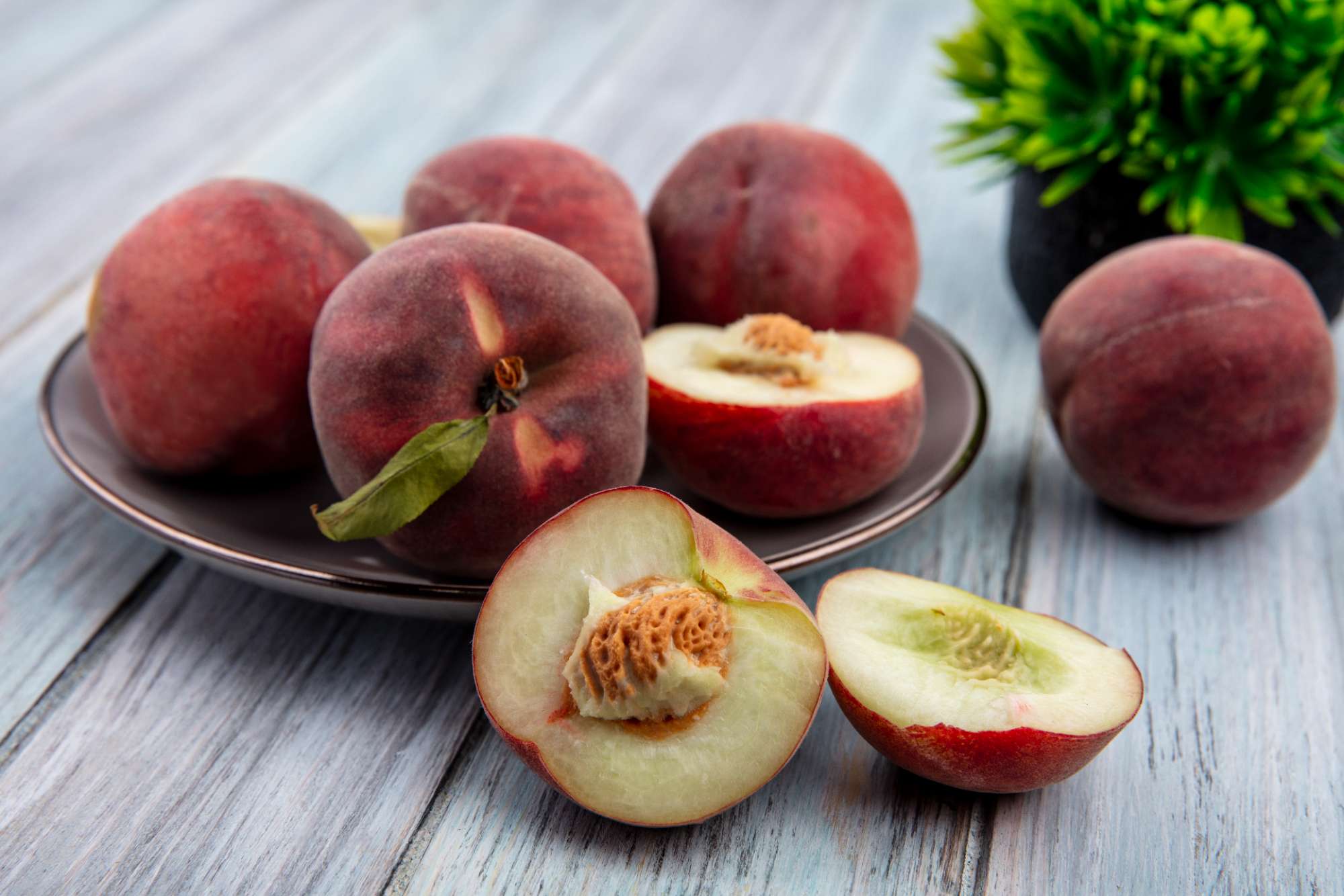 front-view-fresh-sweet-delicious-half-peaches-plate-grey-wooden-surface.jpg
